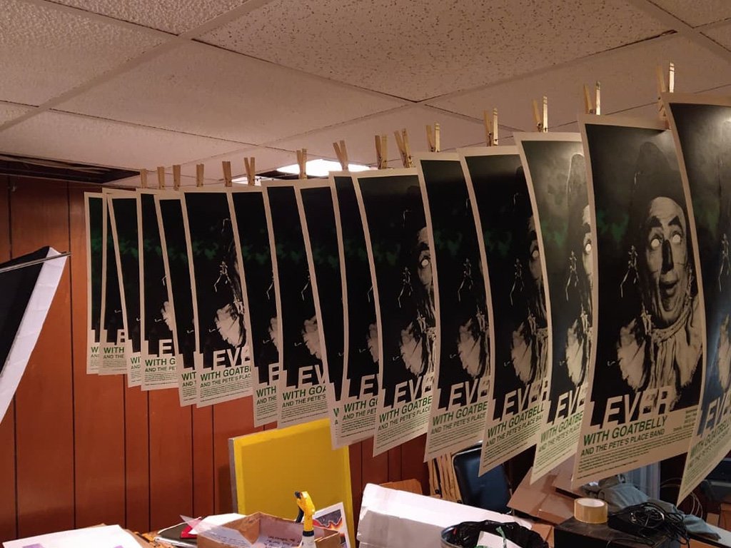 A group of hand printed posters hanging in my studio.